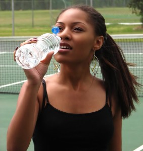 5176-a-beautiful-teen-african-american-girl-drinking-water-on-a-tennis-court-pv
