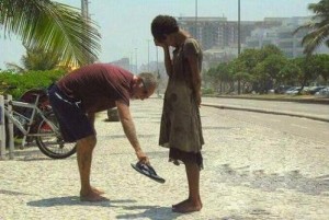 man-giving-poor-chid-shoes